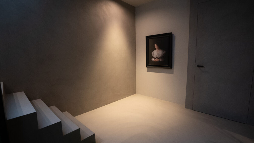 Minimalist hallway with artwork and stairs