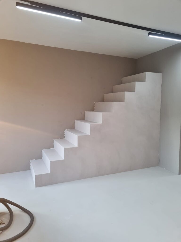 Minimalist white staircase against wall